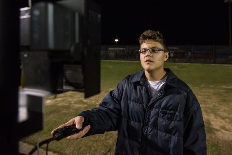 Zeke Romero films the Eagles as they take on Lakeworth on Nov. 12, 2015 in Denton, Texas. (Christopher Piel/The Talon News)