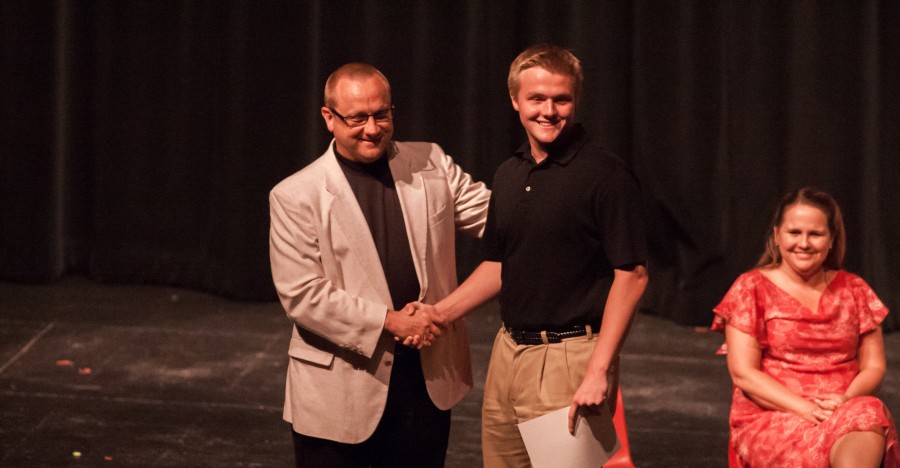 Sophomore Jett Monroe shaking hands with Principal Jeff Butts after his induction to the National Honor Society. Left to right: Jeff Butts, Jett Monroe, and Jennifer Fischer.