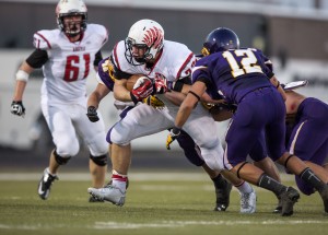 Junior Nick Ralston runs the ball against #12 Bulldog during the game against Abilene Wylie (38-0) in Abilene Aug. 30.  Photo by Matt Garnett