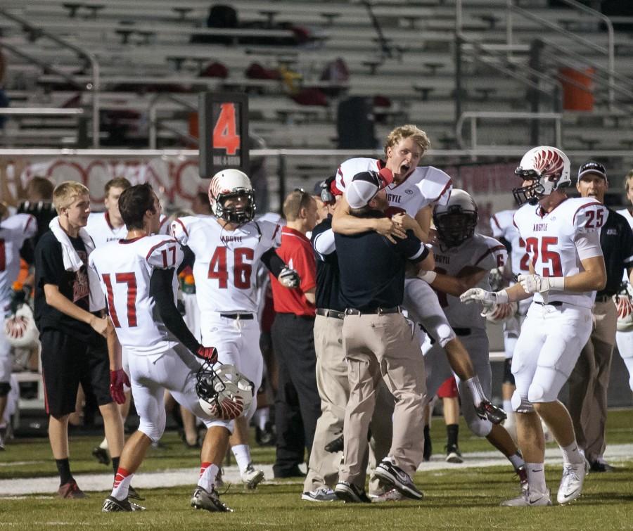 Senior Cole Hedlund celebrates with Coach Jason Pitts after he makes a record breaking 57 yard field goal against Abilene Wylie, helping to win the game 38-0 on Aug. 30 in Abilene.  Photo by Matt Garnett