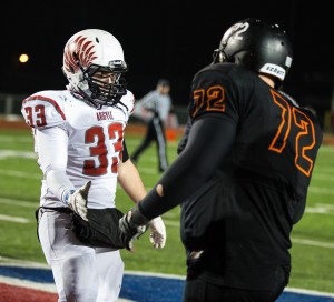 Argyle defensive lineman Reagan Page (33) shakes Gladewater offensive lineman Justin Stadtfeld's hand  concluding the game at Waco Midway's Pather Stadium in Hewitt, Texas on Dec. 9, 2013. Argyle defeated Gladewater in the 3A D2 region 2 finals 42-8.  Photo by Matt Garnett