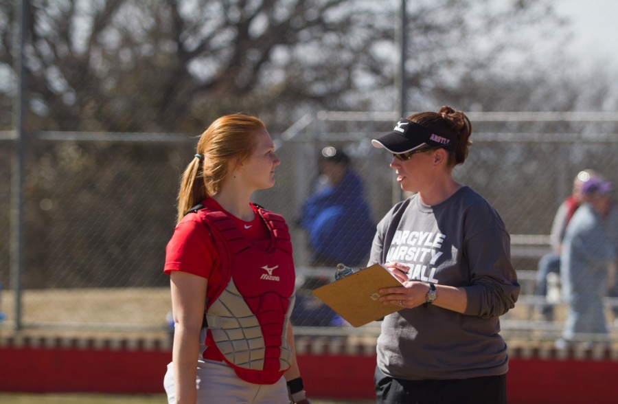 Cheyennea Althoff discusses game strategy with coach Coonrod.