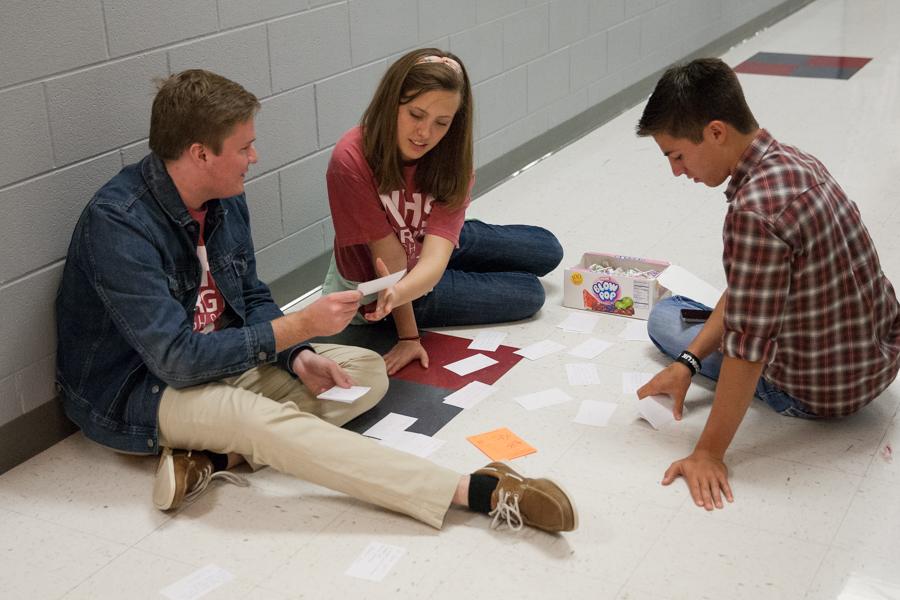 NHS officers Vanessa Zielinski and Evan Welsh work with junior Preston List to hand out candy-grams on Argyle Day of Kindness on Nov. 19, 2014 at Argyle High School. (Annabel Thorpe / The Talon News)