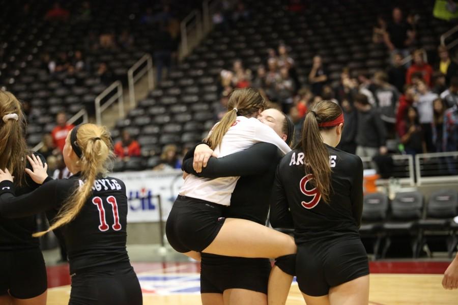Maddie DeGuire celebrates with Alexa Bass and fellow Argyle Eagle teammates as they win against Liberty Hill Robinson in the state semi-finals at Curtis Culwell Center Nov. 21, 2014.  Photo by Annabel Thorpe | The Talon News