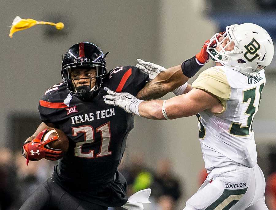 Texas Techs DeAndre Washington (21) is penalized for a face-mask against Baylor Saturday, Nov. 29, 2014, at AT&T Stadium in Arlington, TX. Matt Garnett/The Talon News