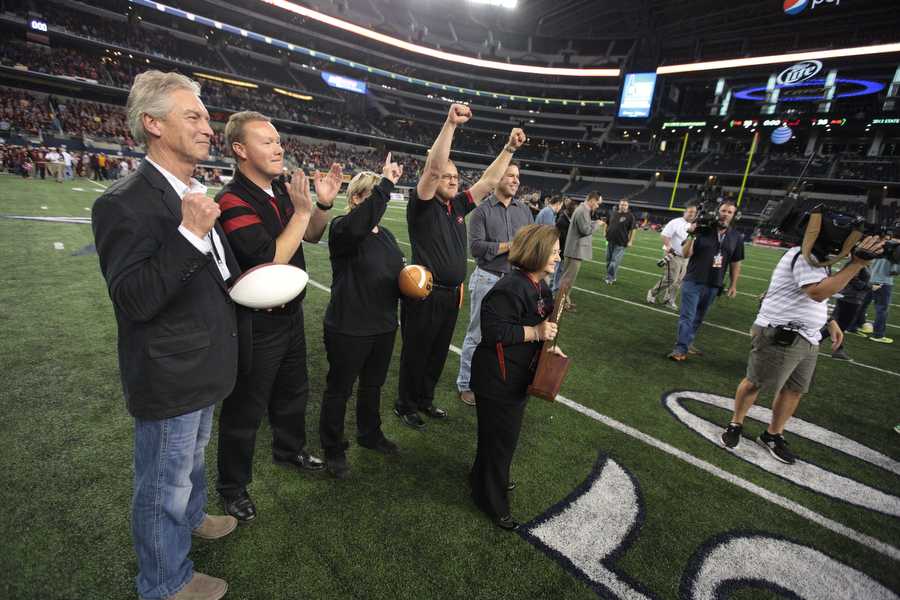 Jeff Butts celebrates with the Argyle ISD administration after the football team’s state championship victory at AT&T Stadium over the Fairfield Eagles on Dec. 20th, 2013.  This was Butts second time to step on the AT&T field for an Argyle state championship football game.  (Matt Garnett/The Talon News)