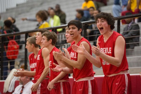Varsity basketball members cheer on their team mates during their final game against Triple-A Academy on Mar. 5, 2015. (Caleb Miles / The Talon News)