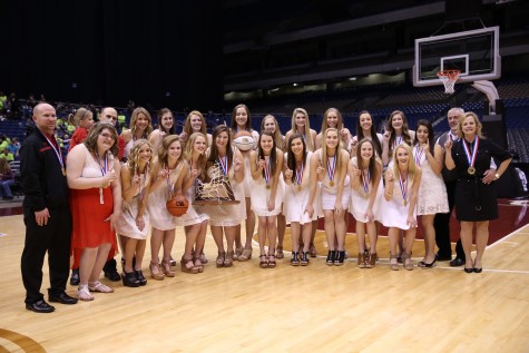 The Lady Eagle basketball team poses with their new trophies after the UIL state championship award ceremony. (Annabel Thorpe / The Talon News)