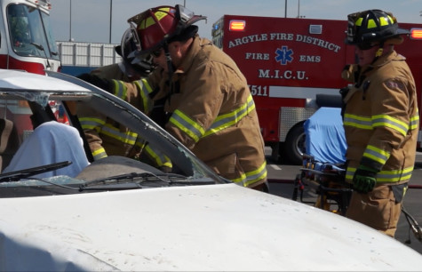 Fire department personnel observe the crash scene during the Shattered Dreams program on May 20, 2015 at Argyle High School. (Greg Royar)