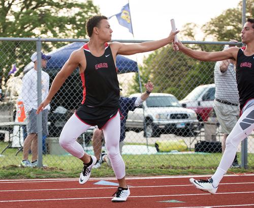 Erik Ramon takes the hand off from Zach Zembraski in the 4x4 at Aubrey High School on April 9, 2015. (Photo by Annabel Thorpe/ The Talon News)