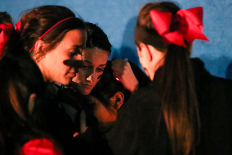 Kaylie Pool embraces the youngest Ledesma daughter during the Candlelight Vigil on April 3, 2015 at Argyle High School. (Annabel Thorpe/ The Talon News)