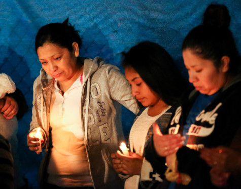 The Ledesama family lights their candles at the Candlelight vigil to commemorate the loss of their family member Julio Ledesma on April 3, 2015 at Argyle High School. (Annabel Thorpe/ The Talon News)