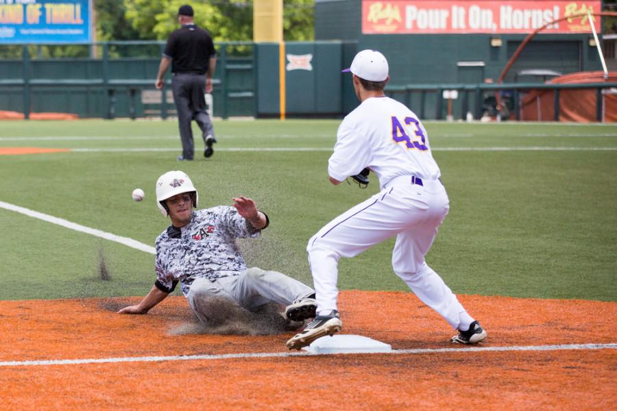 Junior Tanner Boyzuick slides into the third beating the ball to Tyler Henson in the 9-4 win over Abilene Wylie.