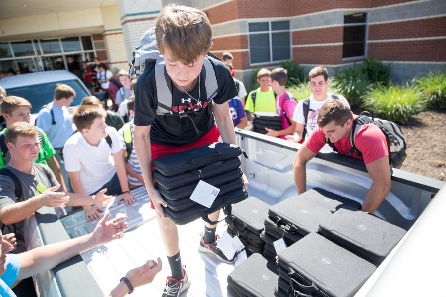Football players unload Chromebooks for the high school on (9-2-15) (Caleb Miles / The Talon News)