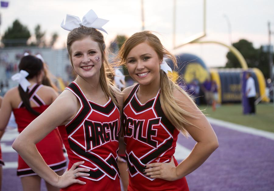 Juniors Allison McNiel and Haylee Holt enjoy pregame pictures before Argyle takes on Abilene Wylie at Bobcast Stadium on August 28, 2015. (Annabel Thorpe / The Talon News)