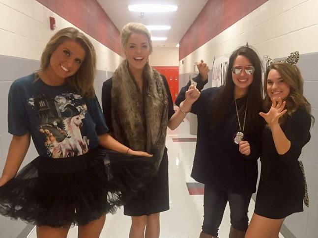 Seniors Eighmy Dobbins, Emma Malone, Heather Lindemann, and Micki Hirschhorn all pose for a picture in the hall today as they show off their Halloween costumes. (Micki Hirschhorn / The Talon News)