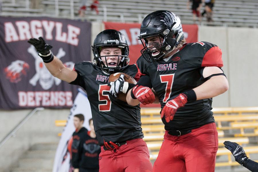 Seniors Gage McCook (5) and Taylor Sweatt (7) celebrate after McCook ran in the game winning touchdown to defeat Abilene Wylie 24-17 on Friday, Dec. 11 at McLane Stadium in Waco, TX.  Argyle will advance to the state finale next Friday to play La Vega at the NRG Stadium in Houston, TX. (Caleb Miles / The Talon News)