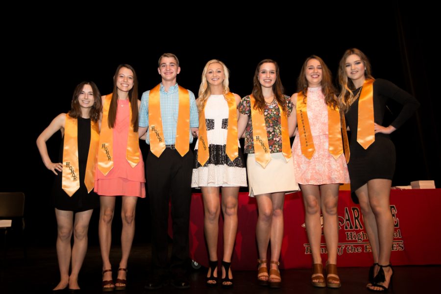 Top ten graduating students of the class of 2016 stand on stage from left to right: Ashley Ridenour (10), Kaylie King (9), Travis Koczo (6), Lilly Carter (5), Sarah Llewellyn (3), Claire DeSpain (2), Carleigh Klusman (1). (Not pictured: Tanner Boyzuick (4), Brandon Couch (7), Shashwat Tripathi (8)). at the end of the year award ceremony on Monday, May 16 in Argyle, Texas. (Annabel Thorpe / The Talon News)