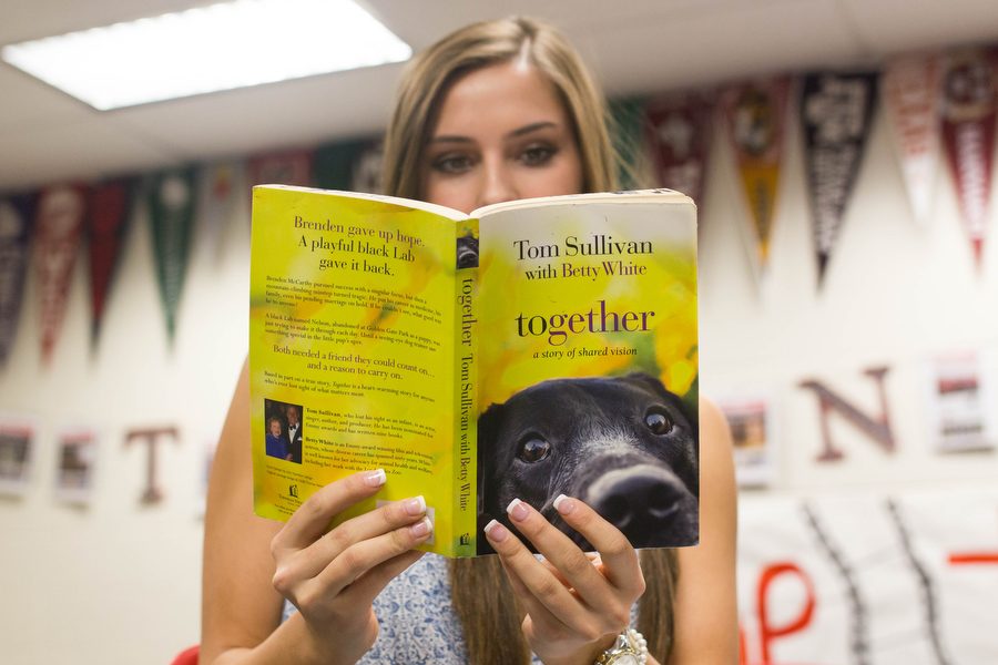 Junior Lizzie Dagg reads Together: A Story of Shared Vision, by Tom Sullivan and Betty White on September 26, 2016 in Argyle High School (Faith Stapleton/The Talon News)