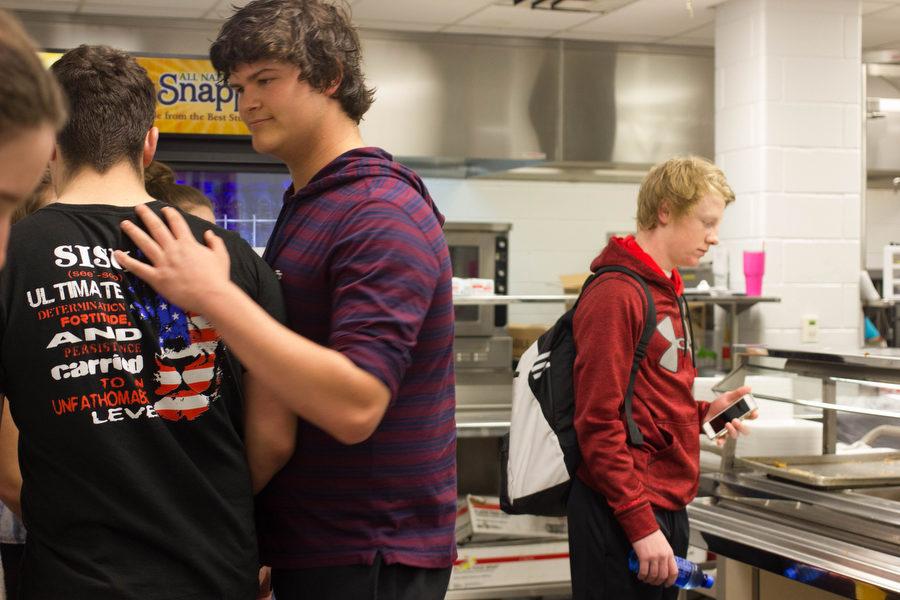 Freshman Jake Sullivan and Andy Buttrell stand in line while waiting to receive their school lunch at Argyle High School on March 7, 2017 in Argyle, Texas. (Kenzie Hindman/ The Talon News)