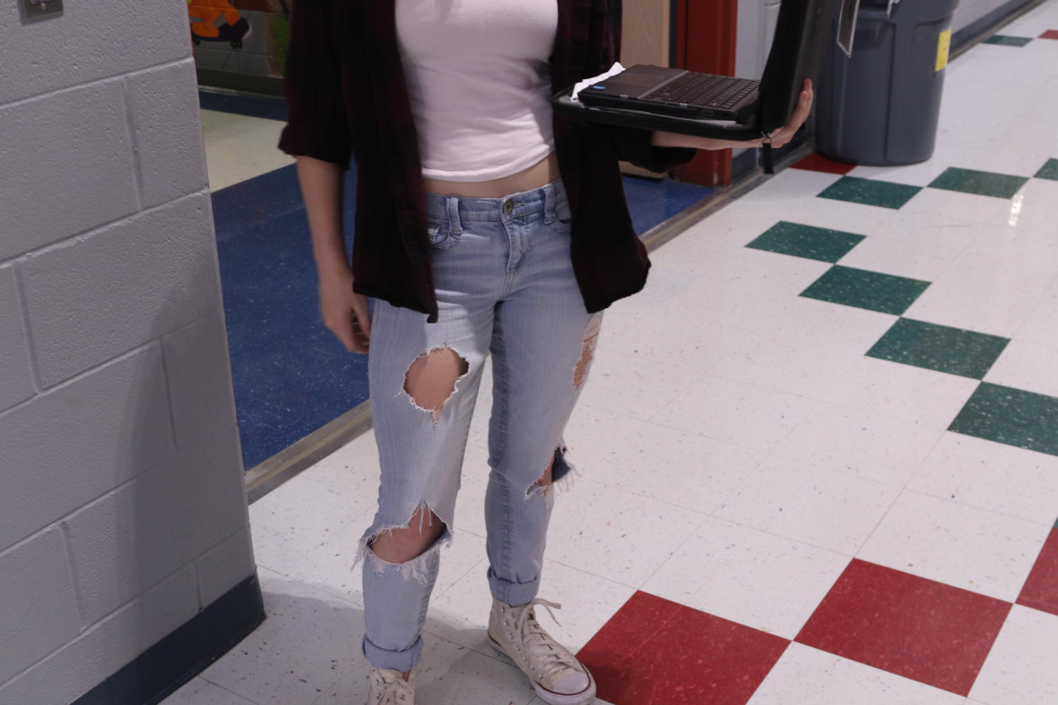 Anonymous student walks to class while out of dress code with rips in jeans and too short shirt, she was not dress coded though. (Elli Marusa/The Talon News)