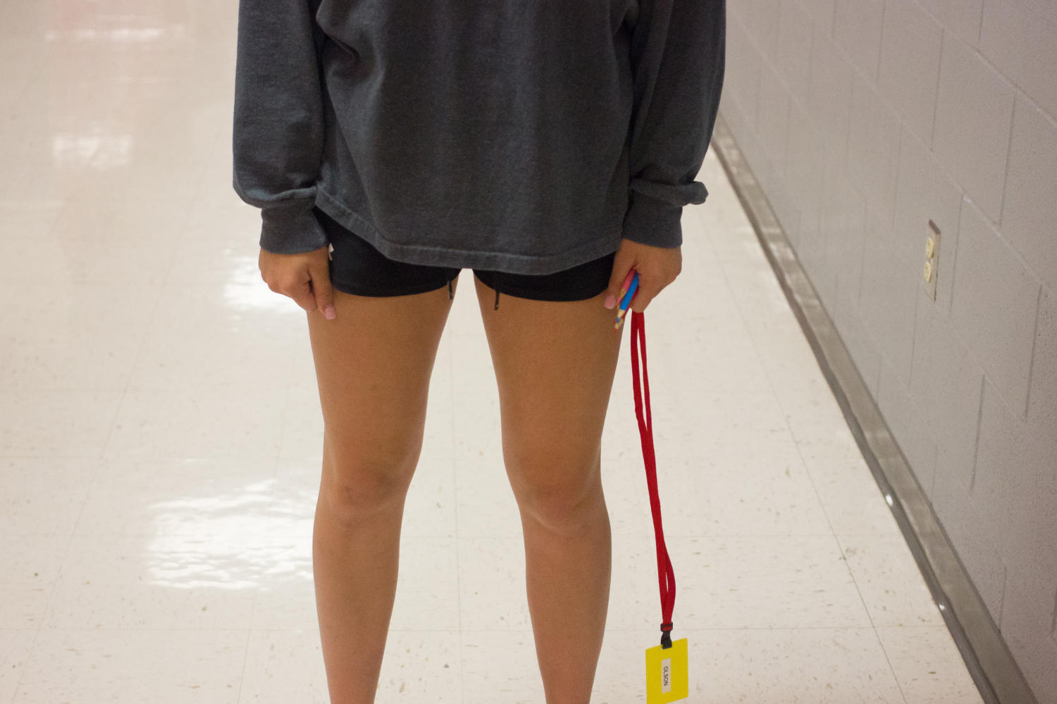 Underclassmen stands in hallway out of dress code because shorts are not past her knuckles, this student was not dress coded that day.   (Elli Marusa/The Talon News)