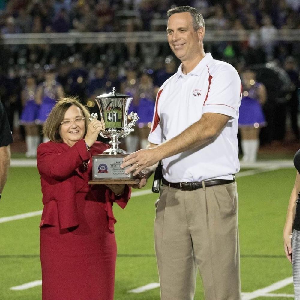 Superintendent Telena Wright and Principal James Hill received Argyles sixth consecutive Lone Star Cup at last nights game, raising the schools Lone Star Cup holdings to eight in total. (Quinn Calendine/The Talon News)
