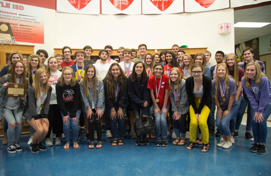 UIL Academics students pose in front of the trophy case at Argyle High School with their UIL Region 2-4A medals on April 16, 2018 in Argyle, TX. (Campbell Wilmot/The Talon News)