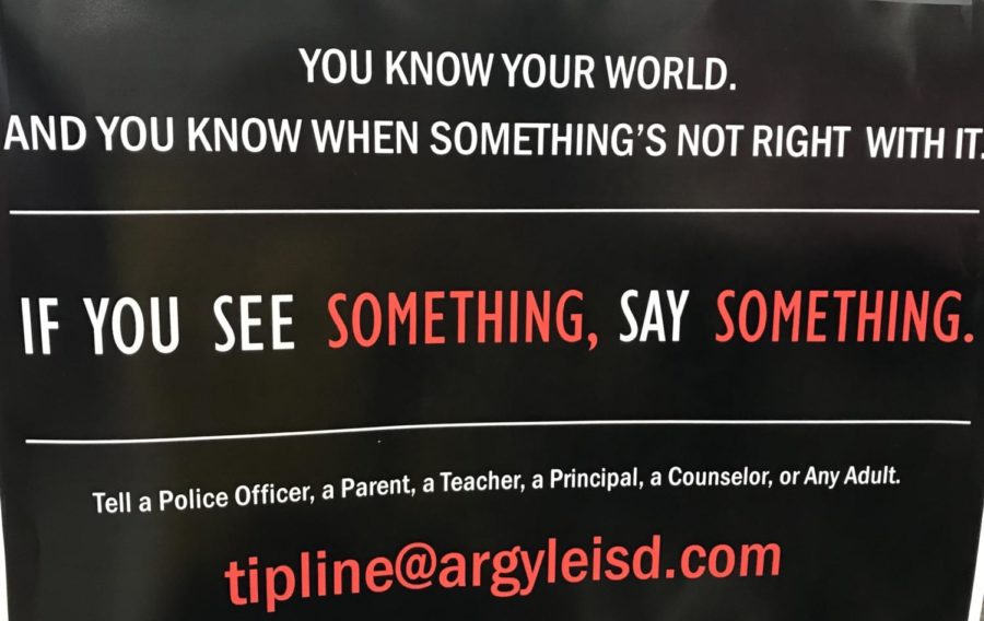 Posters hang in classrooms and hallways displaying the tipline students can submit information to at Argyle High School in Argyle, TX on April 18, 2018. (Miranda Downe/The Talon News)