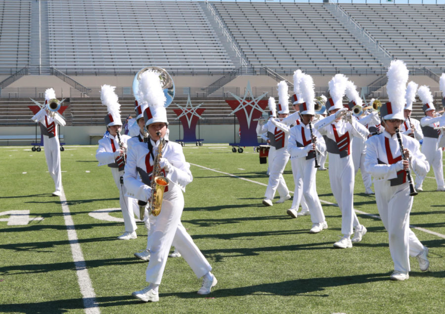Putting thier hearts into the performance, stundets of the marching band preform at the Area Marching Contest prior to State. (The Talon News / Jaclyn Harris)