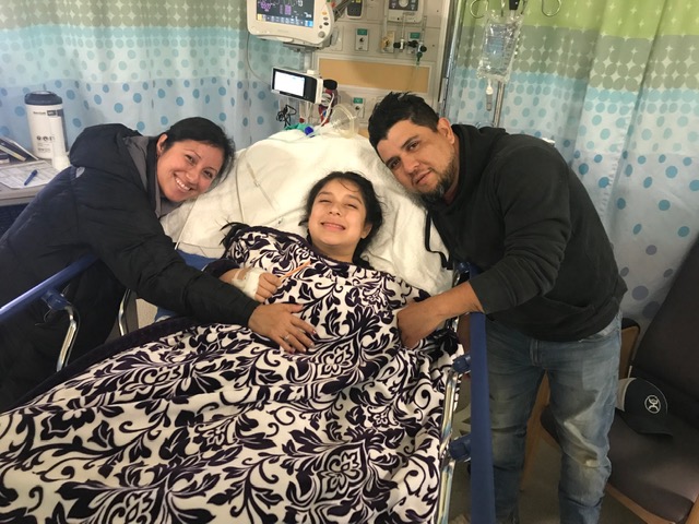 Kate Villanueva and her parents at the hospital after her brain surgery on Jan. 29. (Photo by: Gloria Arredondo)