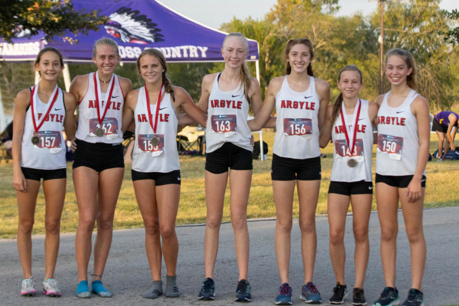 The Argyle Eagles Cross Country team shows off their medals at the Gingerbread Jamboree at Camp Copass in Denton, Texas, on August 29, 2019. (Andrew Fritz | The Talon News)