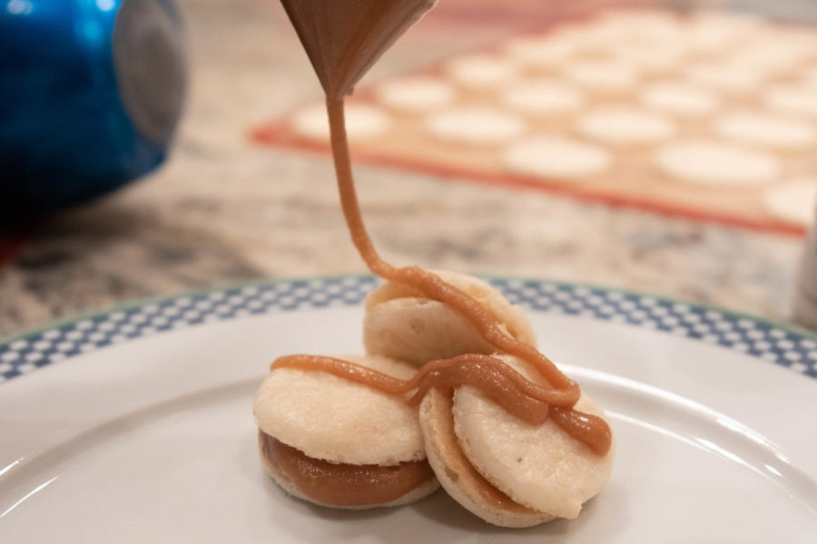 The macarons turned out less than ideal to say the least. We tried piping some caramel on top, but the fact that it was too thick coupled with the lack of food coloring (we couldnt find any in the store) left them lacking in the aesthetic department. (Andrew Fritz/ The Talon News) 