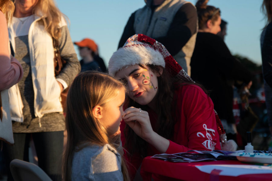 Senior Paige Pakebusch helps out at the face painting booth. (Katie Ray | The Talon News) 