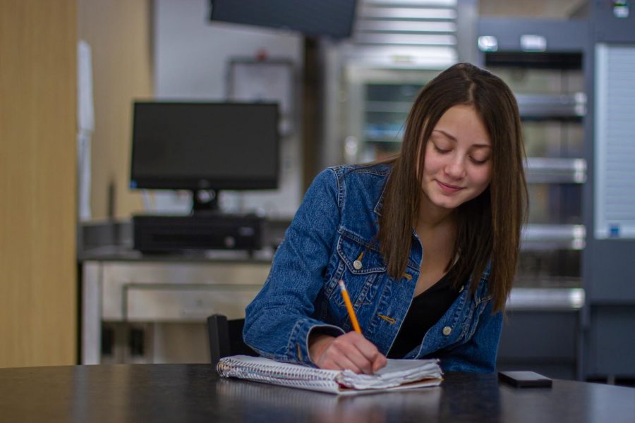 Estelle Brower journals her  experiences as a way of overcoming the past. (Emma Campbell / The Talon News)