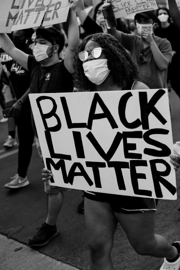 A protester holds a sign at the Black Lives Matter rally in the Denton square on Monday, June 1 2020.