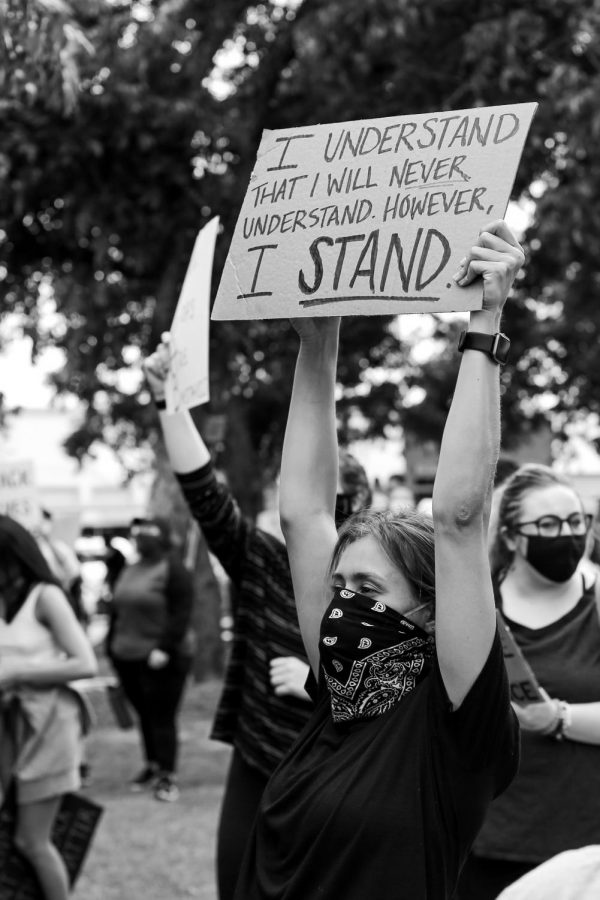 A protester holds a sign at the Black Lives Matter rally in the Denton square on Monday, June 1 2020.