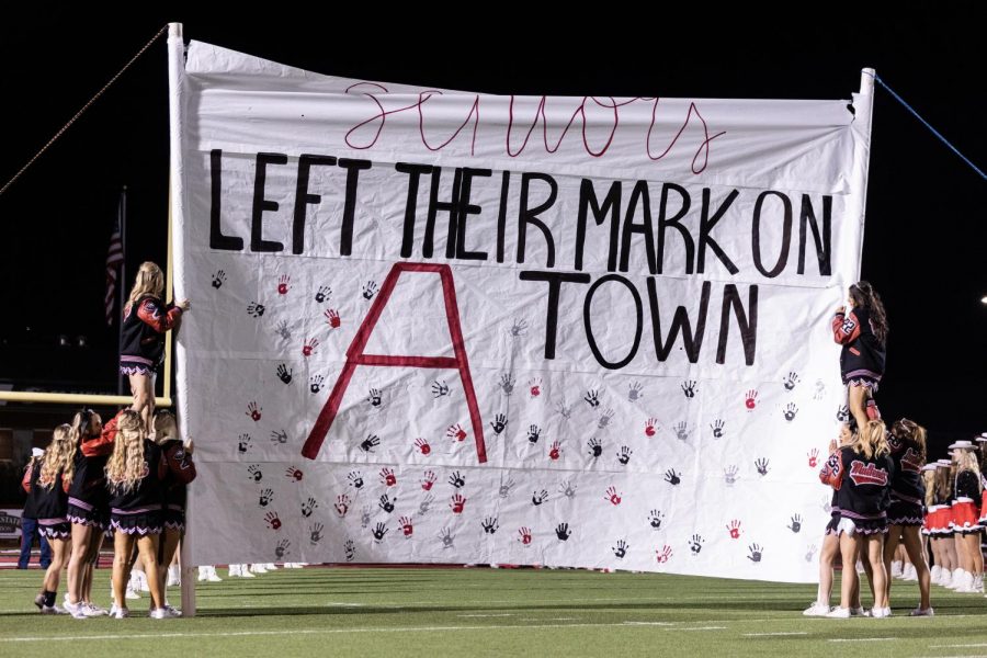 Argyle cheerleaders hold up banner for senior night on November 5, 2021.