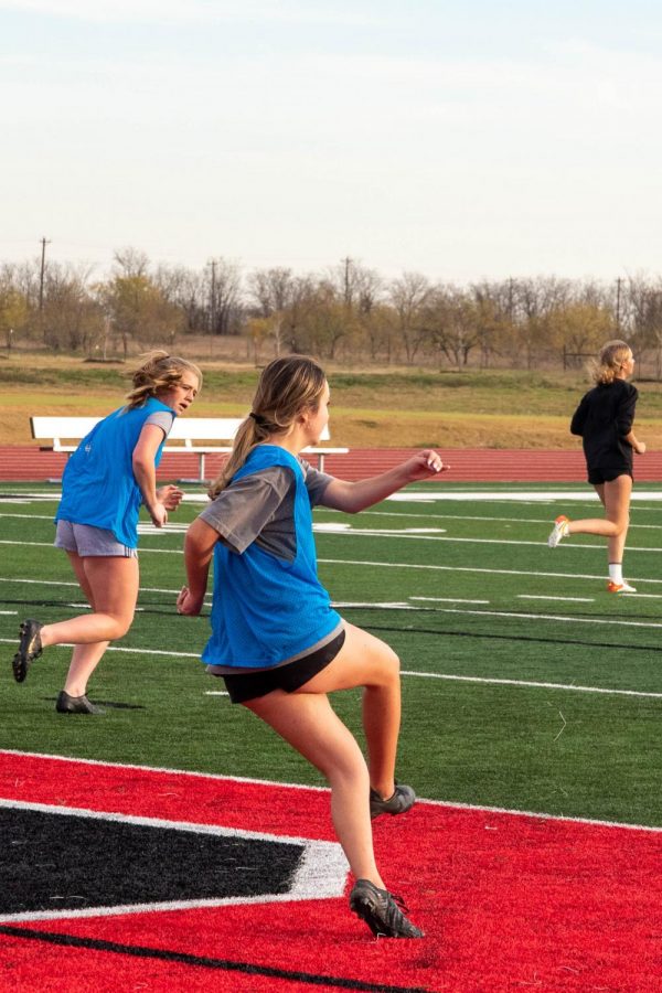 Junior Moriah Offner kicks the ball to midfield as teammates chase it upfield. Offner plays defense and helps the team set up for the upcoming season. “We’ve gone undefeated in our district games, which encouraged us to set higher goals this season,” junior Ella Atkins said.
