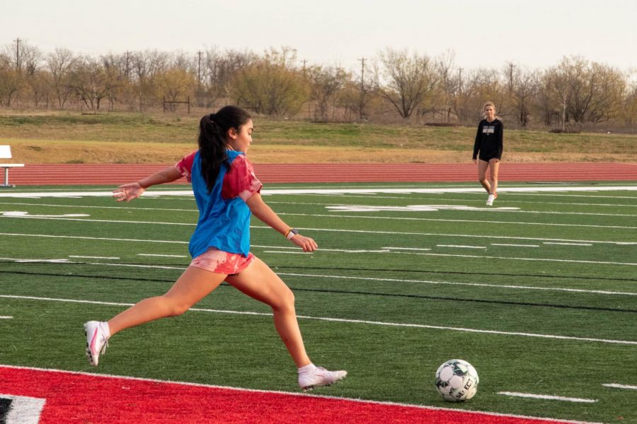 Freshman Hannah Solano takes a shot to kicking the ball upfield. Solano takes on the new season as playing defense for varsity this year. “Improving overall as a player has led our team to take each opportunity as to get better and using each other’s advice to improve this season,” junior Ella Atkins said.