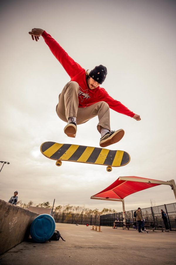 Max Calabrese kick flips over the block at Railroad Park, Lewisville, Texas, on Dec. 16, 2021. 