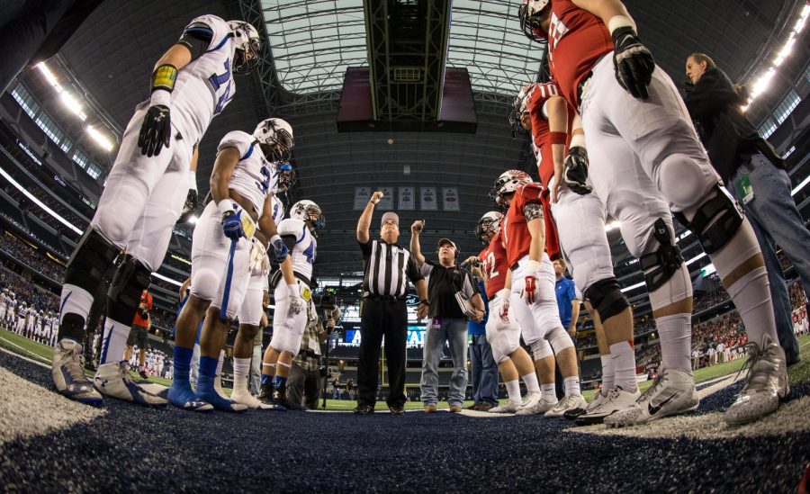 Referees flip the coin on Dec. 19, 2014 prior to kickoff for the state championship game Argyle vs. Fairfield. High school and college possession rules differ from the NFL, which are currently under fire. 