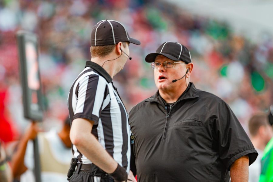 University of North Texas coach talks to the sideline referee during a bowl game against Miami University. 