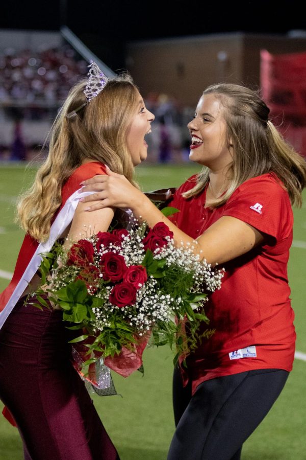 Senior Kimberly Giese is crowned homecoming queen on Oct. 22 at Eagle Stadium in Argyle, Texas. Following the announcement she and her close friend Sophie Slaton celebrate the achievement. (Cate Clark | The Talon News)