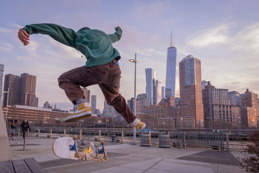 Leo Seandel kickflips over the block in front of the World Trade Center on Pier 26 on the East coast of Manhattan Island on Dec. 31, 2021.