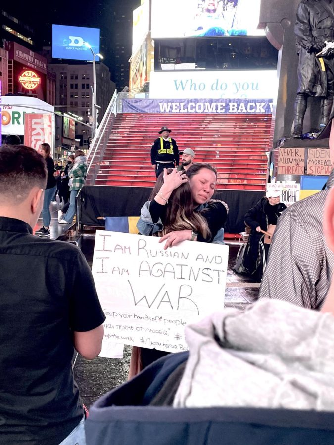 Russian citizen and a Ukrainian woman apologize to one another for a war neither of them started in Times Square, NY, on March 6, 2022.