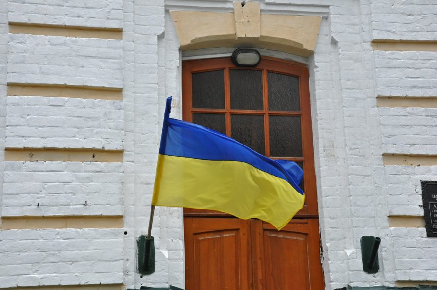 Ukrainian flag flying next to St. Nicholass Church by Anosmia is marked with CC BY 2.0.