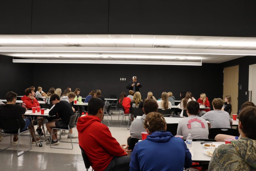 FCA members listen to a guest speaker as they gather for breakfast before school.
