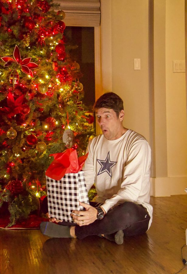 Harlie Bodine opens up a gift in his living room on December 10, 2022.
