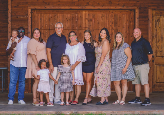 Teacher Caroline Robertson stands with family for photo in the summer time. (Photo Courtesy of Caroline Robertson)